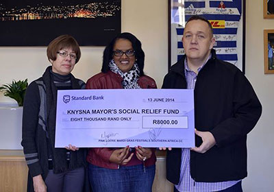  Pink Loerie Mardi Gras & Arts Festival Knysna hands over R8000 to Knysna Mayor's Social Relief Fund.  From Left to Right: Karin Sephton (Pink Loerie), Knysna Executive Mayor Georlene Wolmarans and John O'Neil (Pink Loerie) 