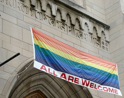Rainbow flag above the entrance to a Presbyterian church
