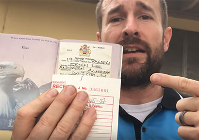 Anderson holds up his Malawi visa
