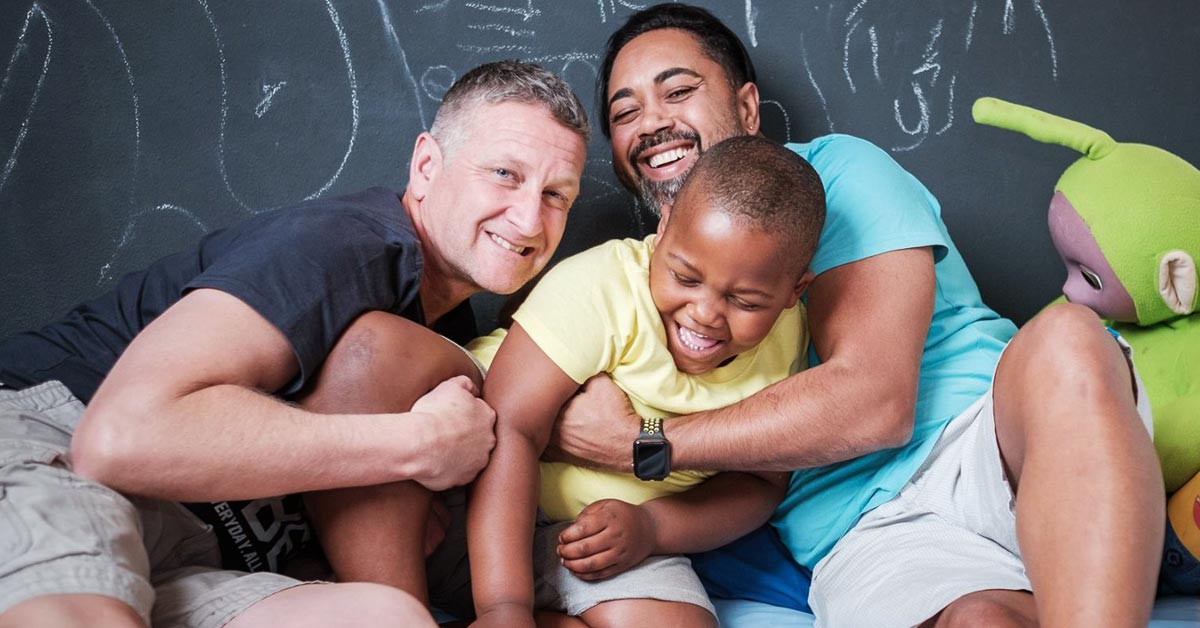 Gay dads Darren and Emanuel Kelly-Loulié and their son Jeremy