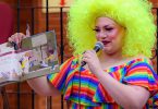 A drag queen reads from a children's book