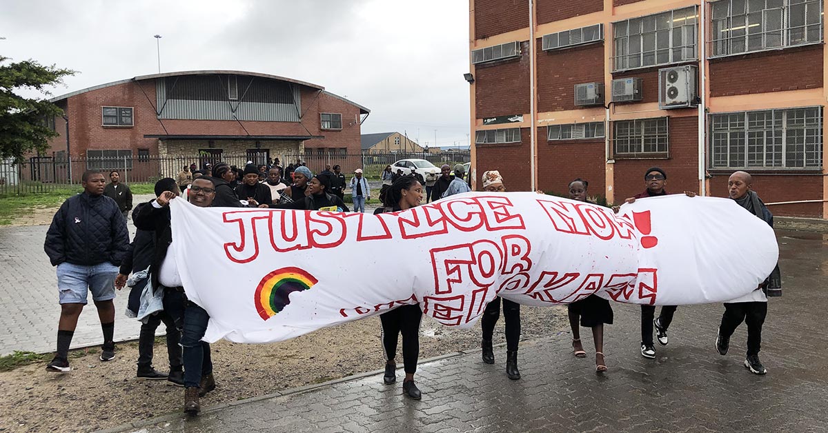Friend and family hold up a banner calling for justice for Phelokazi Mqathanya